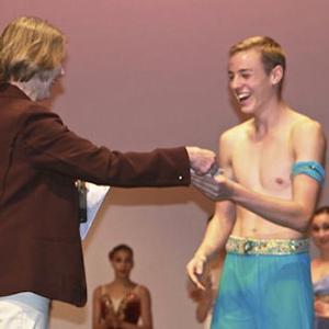 Aurelian accepts his prize from Marilyn Jones, the artistic director of the Australian Institute of Classical Dance.