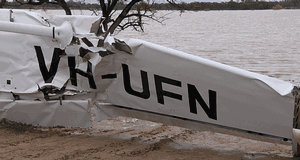 VH-UFN's left wing with its flattened leading edge and a rupture. (ATSB)