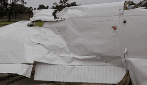 The upper surface of the left wing, showing the ruptured section and adjacent scoring and paint transference. (ATSB)