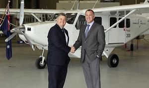 Hawker Pacific Senior VP Tony Jones (left) accepts the 200th GA8 Airvan from GippsAero CEO Terry Miles. (GippsAero)