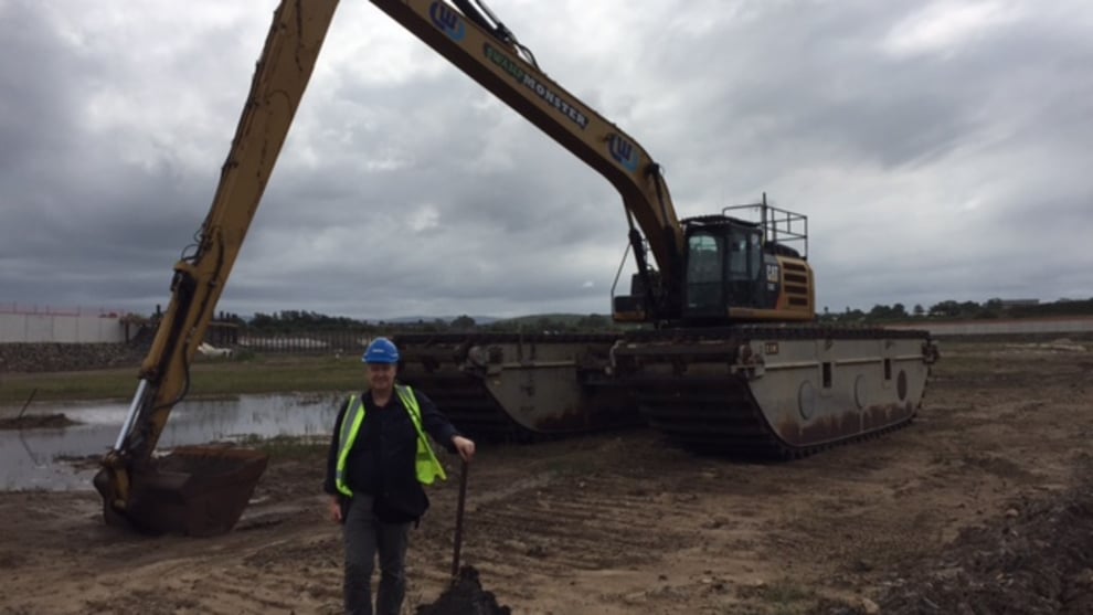 Marine Business editor Simon Enticknap with one of the excavators being used to create the harbour.