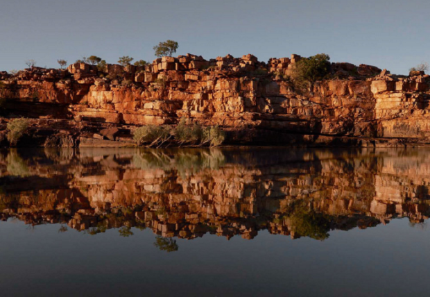 Sandstone escarpments of Sir John Gorge reflected in the Fitzroy River.