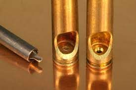 Flash holes un-deburred (L) and deburred (R).