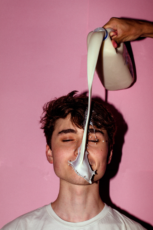 © James Dryden. 2nd Place - Student Prize. Spilt milk. A portrait focusing on forced advertising of commercial products.