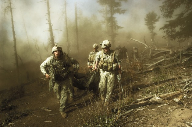 © Lynsey Addario. U.S. troops with the 173rd Airborne, Battle Company, carry the body of Staff Sgt. Larry Rougle after he was killed in an ambush during Operation Rock Avalanche in the Korengal Valley, October 2007.