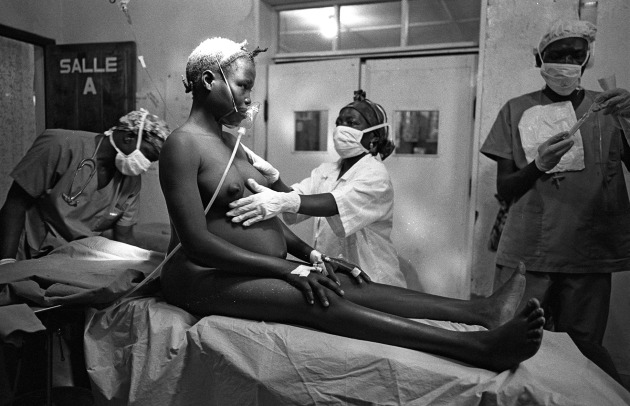 © Gary Knight. A woman giving birth at Hôpital Bon Marché, Bunia, Congo, June, 2005. A former coffee warehouse adjacent to Bunia Airstrip, the Médecins sans frontières hospital is the only fully functioning hospital for hundreds of kilometres that offers free healthcare to all indigenous tribes.