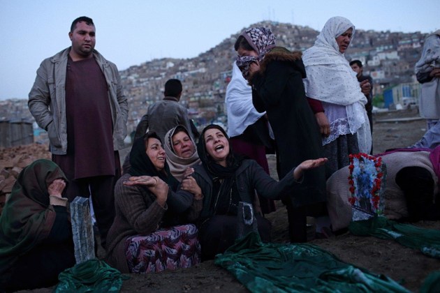 At dawn, the day after seven young boys were killed by an explosion while they were believed to be playing with a piece of unexploded ordinance, women of the boys’ families mourn at the cemetery in Karte-y Sakhi, where the seven were buried side by side the day before. Shot for The New York Times. © Andrew Quilty.