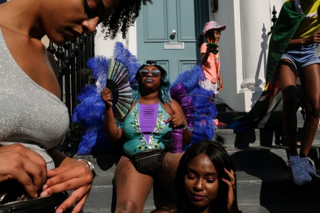 © Olesia Kim. Londoners. This image was taken on the steps of a Notting Hill house in London. The neighborhood comes alive every year for a colorful and joyful carnival.