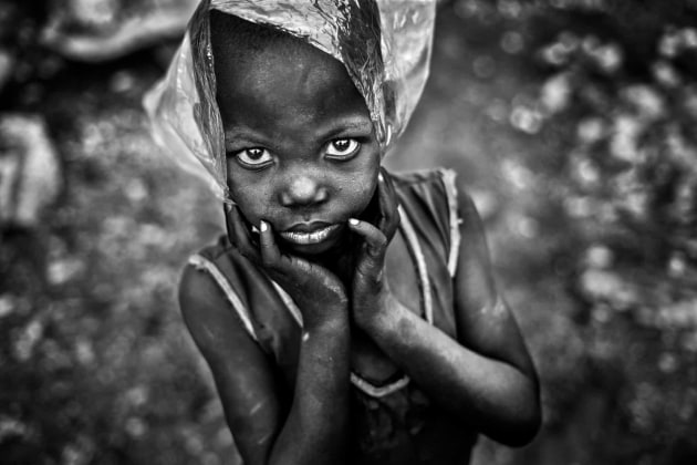 Photograph: Aragon Renuncio/2019 CIWEM Environmental Photographer of the Year. The Plastic Quarry. A boy plays with a plastic bag. About 380m tonnes of plastic is produced worldwide each year. Production increased exponentially from 2.3m tonnes in 1950 to 448m tonnes by 2015. Every day approximately 8m pieces of plastic pollution find their way into our oceans. Ouagadougou, Burkina Faso.