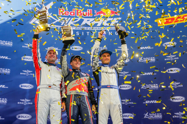 Matt Hall raises the trophy on the Lausitz podium with second-placed Matthias Dolderer (L) and third-placed Pete McLeod (R). (Daniel Grund/Red Bull Content Pool)