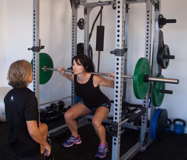 Sarah assists a client with strength training. Image: Sarah Hunter FTP Training.