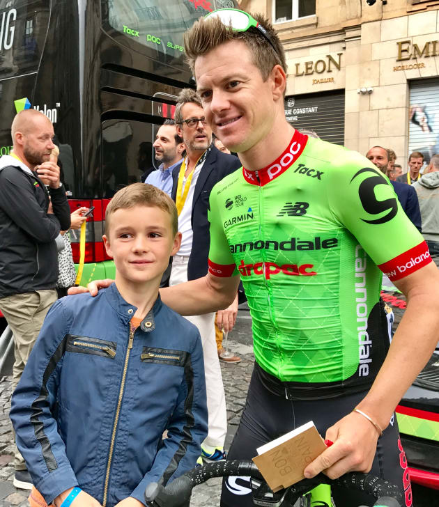 Simon Clarke with a young fan after the finish of the 2017 Tour de France in Paris. Image: Nat Bromhead.