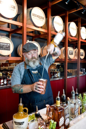 Venue manager Gavin Butler pours a drink at the Eagleby distillery.