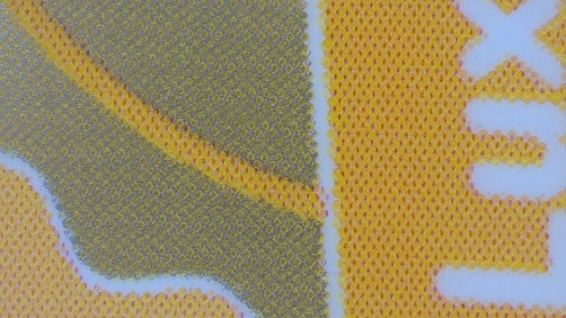 Under the microscope: X 60 close-up of the gold achieved with overlapping of colors perceived as one color by the human eye.