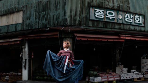 Fujifilm GFX 50S, 110mm f/2, 1/250, f/2.8, ISO 100, Godox AD200 in 1.5m umbrella to camera left, panorama stitched in Photoshop CC. Hanbok, Korea's traditional dress in a street market.