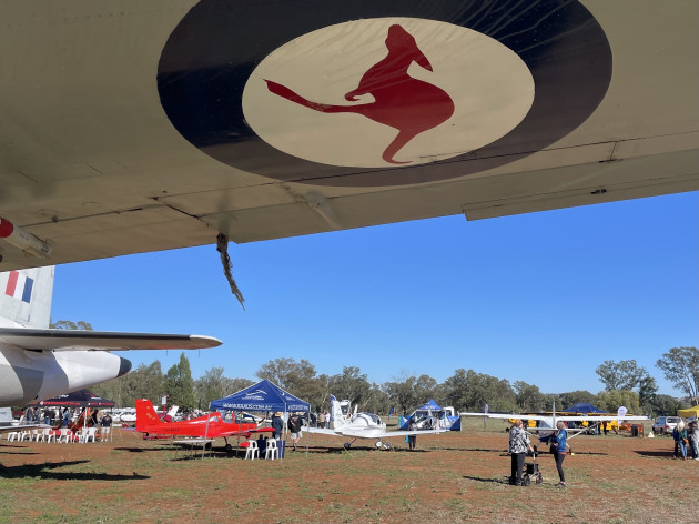 Under the wing at Fly&rsquo;n For Fun, with light aircraft and exhibitors spread across the field. (Beni McDonald)