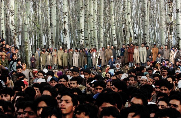 © Ami Vitale. Villagers mourn the death of five people who were killed along with 48 who were injured, when a grenade exploded in the hands of a man who was seeking to extort money from a family in Badgam district of Kashmir, 10 March, 2004.