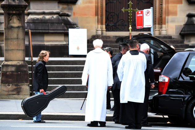 Dean Lewins won the Nikon-Walkley Press Photographer of the Year. Angus Young waits to place a guitar in the hearse with the casket of his brother, AC/DC co-founder and guitarist, Malcolm Young. The funeral was held at St. Mary's Cathedral in Sydney, in November 2017.