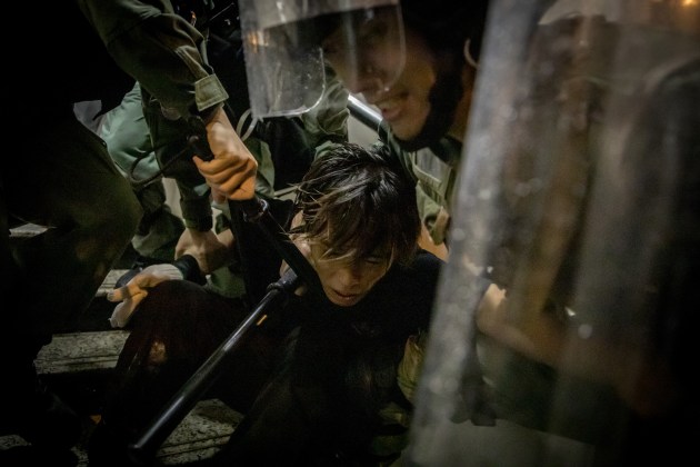 © Chris McGrath. HONG KONG - AUGUST 25: A protester is tackled by police during clashes after an anti-government rally in Tsuen Wan district on August 25, 2019 in Hong Kong, China. Pro-democracy protesters have continued rallies on the streets of Hong Kong against a controversial extradition bill since 9 June as the city plunged into crisis after waves of demonstrations and several violent clashes. Hong Kong's Chief Executive Carrie Lam apologized for introducing the bill and declared it 