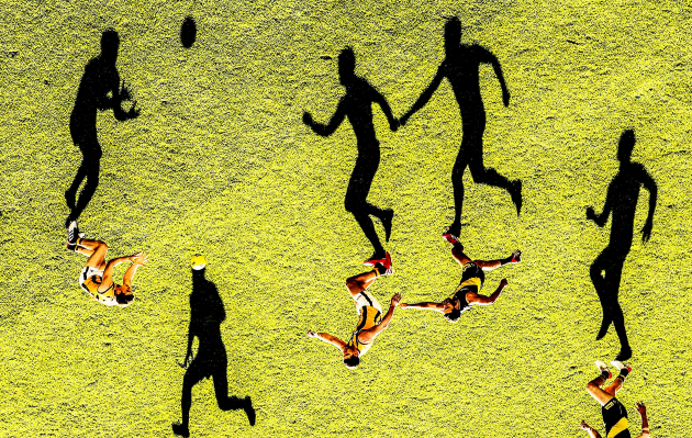 © Scott Barbour. A general view as long shadows are cast by Shane Edwards of the Tigers as he competes for the ball during the round nine AFL match between the Richmond Tigers and the Hawthorn Hawks at Melbourne Cricket Ground on May 19, 2019 in Melbourne, Australia.