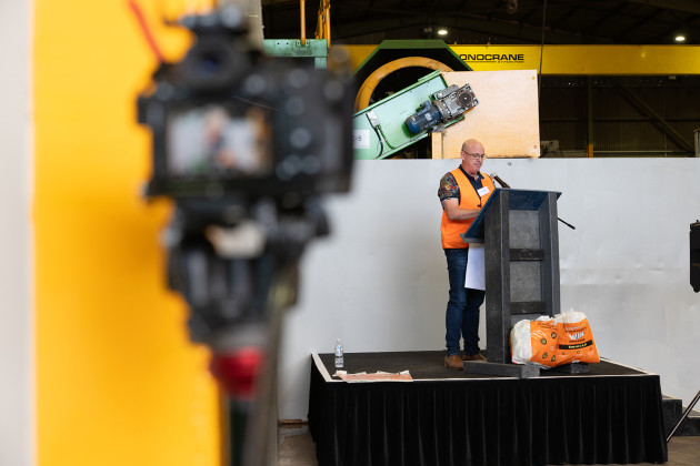 Danial Gallagher addresses guests from a podium made from SPEC-produced material.