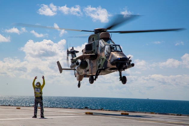 A Tiger ARH departs the flight deck of HMAS Canberra.
Defence