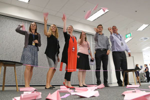 Airservices staff get behind the pink paper plane challenge. (Airservices Australia)