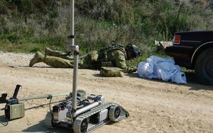 Robots have an integral role within Defence. Having checked out a suspicious vehicle and package via a remote control EOD robot, SGT Terry James from 3 CER and attached to the ANZAC Battle Group, further investigates during a Counter-IED tasking in Nurgal at Cooperative Spirit 08 (Photo courtesy of Defence).