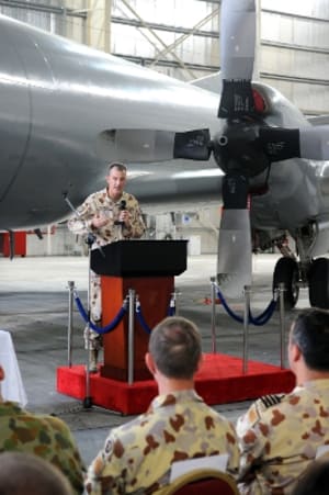 The outgoing Air Component Commander Joint Task Force 633.2, Group Captain Paul Nicholas, addresses the audience at the change of command ceremony. [Photo:Defence]