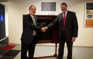 (Left) Director of Maritime Services BAE Bill Saltzer, and the Hon Dr. Mike Kelly AM MP Minister for Defence Materiel, shake hands after officially opening the new Landing Helicopter Dock Training Facility in Mascot, Sydney. [Photo:Defence]