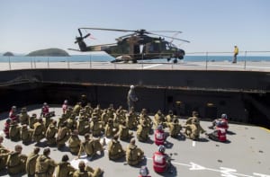 2nd Royal Australian Regiment soldiers ride the aircraft lift from the Troop Assembly Area to the flight deck onboard HMAS Canberra to the waiting helicopter during Sea Series 2015. Credit: Defence