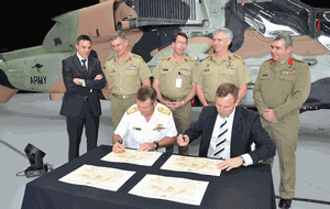 Rear Admiral Mark Campbell and Australian Aerospace CEO, Dr Jens Goennemann sign the delivery documents for the final Tiger Helicopter, ARH22.