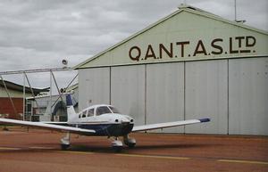 A Piper Archer taxis past the old Qantas hangar at Longreach. (Steve Hitchen)