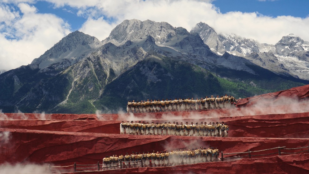 Photographer: Xin Cheng, China

"I waited four days for a clear day at the foot of Yulong Mountain. It was pretty when the local people danced at the red stage against the snow-peaked mountain."