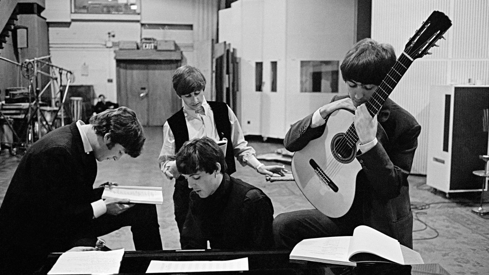 David Hurn
Magnum Photos

The Beatles in EMI Recording Studios, later renamed Abbey Road Studios. London, England.1964.

“In 1964,  I was asked by a friend, who was about to direct the   first Beatles film A Hard Day’s Night (Dick Lester), to photograph the film, not for press, but more from a sociological point of view. In 1963, the Beatles had gained unprecedented fame and status. It could be argued that their only next step could either be down, or to individually go in new directions. They were at crossroads
in their respective careers, and yet had already transformed the music industry. Sometimes people don’t realize the magnitude  of their own achievements; they are clueless to the boundaries they have already crossed to get where they are. My picture shows the four members studying pages of the script for the following days of the film’s shooting. It takes place in the Abbey Road Studio, the scene of so many of their musical triumphs.