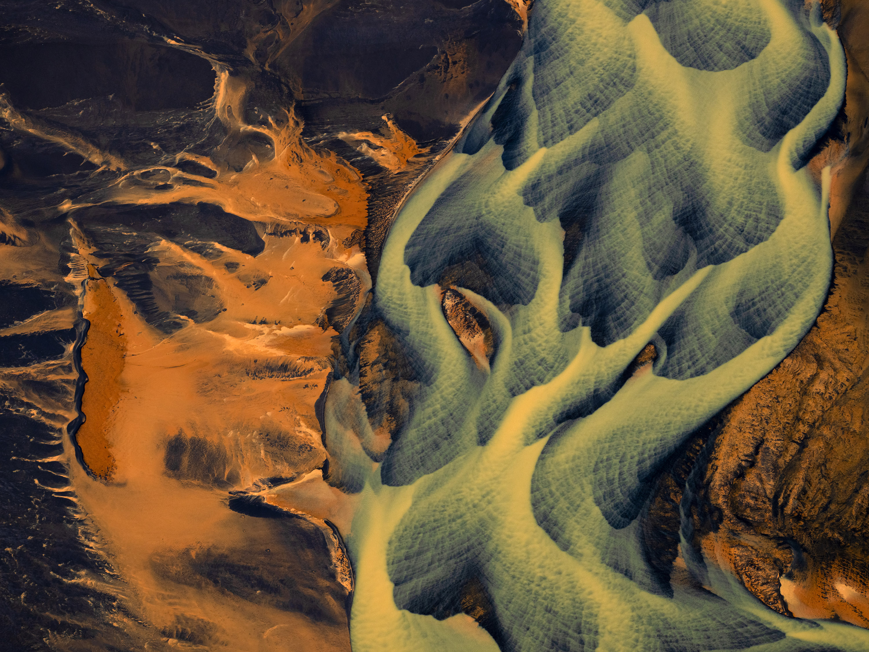 Aerial Photograph, Iceland, 2025In southern Iceland, braided rivers spread across broad outwash plains, dividing and rejoining in endlessly shifting patterns shaped by meltwater from nearby glaciers. As ice melts, torrents of sediment-rich water surge downstream, depositing sand, silt, and volcanic ash in overlapping channels that are constantly rearranged by flow, floods, and seasonal change.