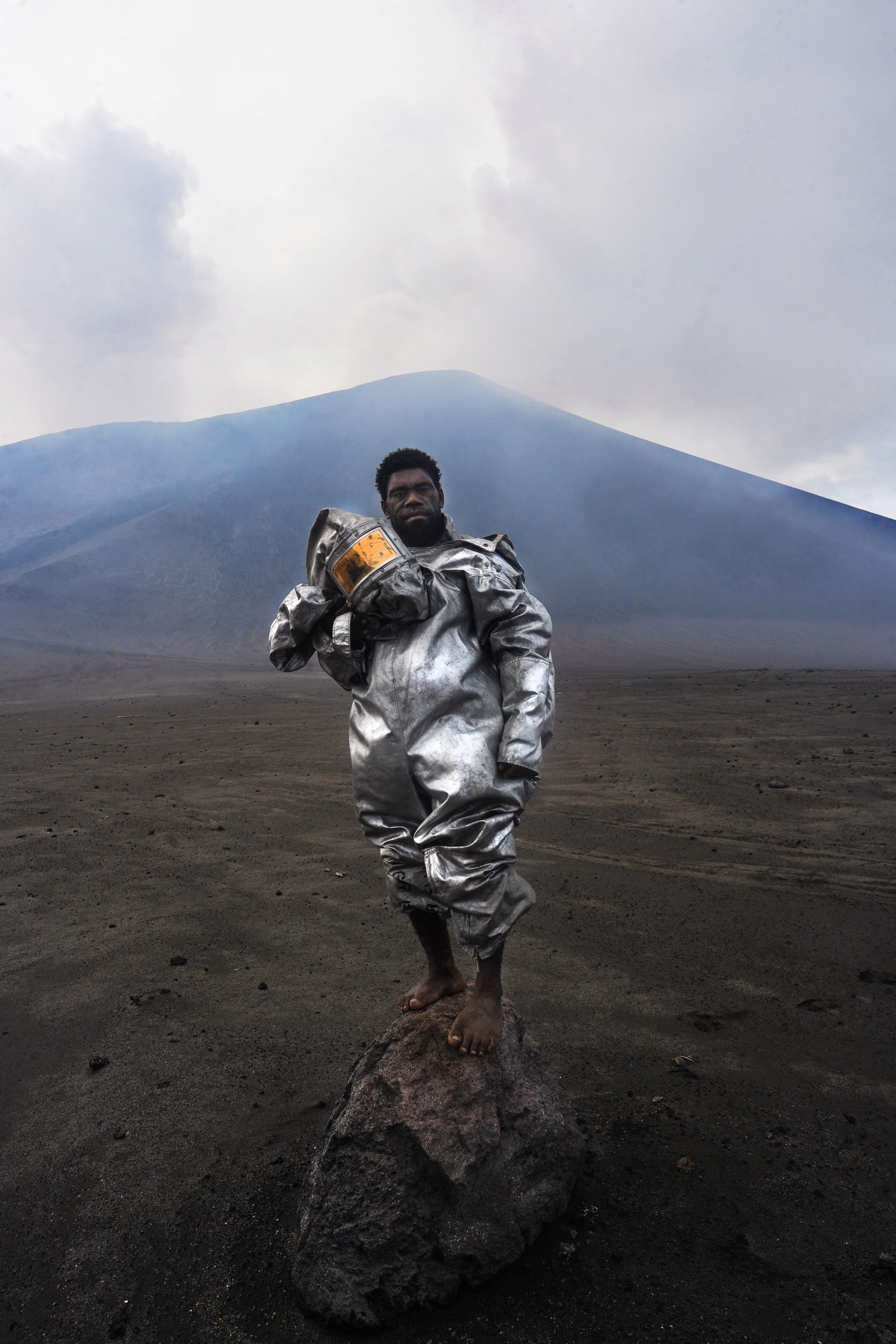 On the ash plains of Mount Yasur, on the island of Tanna, Vanuatu, Phillip, an internationally recognised, self-taught volcanologist, stands barefoot atop a volcanic rock bomb. Wearing a lava-protection suit gifted to him by some visiting researchers, the volcano smoulders behind him, sending a plume of gas and sulphur into the sky. Phillip grew up beneath the active volcano, and this portrait captures him in his element.Copyright: © Elle Leontiev, Australia, Winner, Open Competition, Portraiture, Sony World Photography Awards 2026