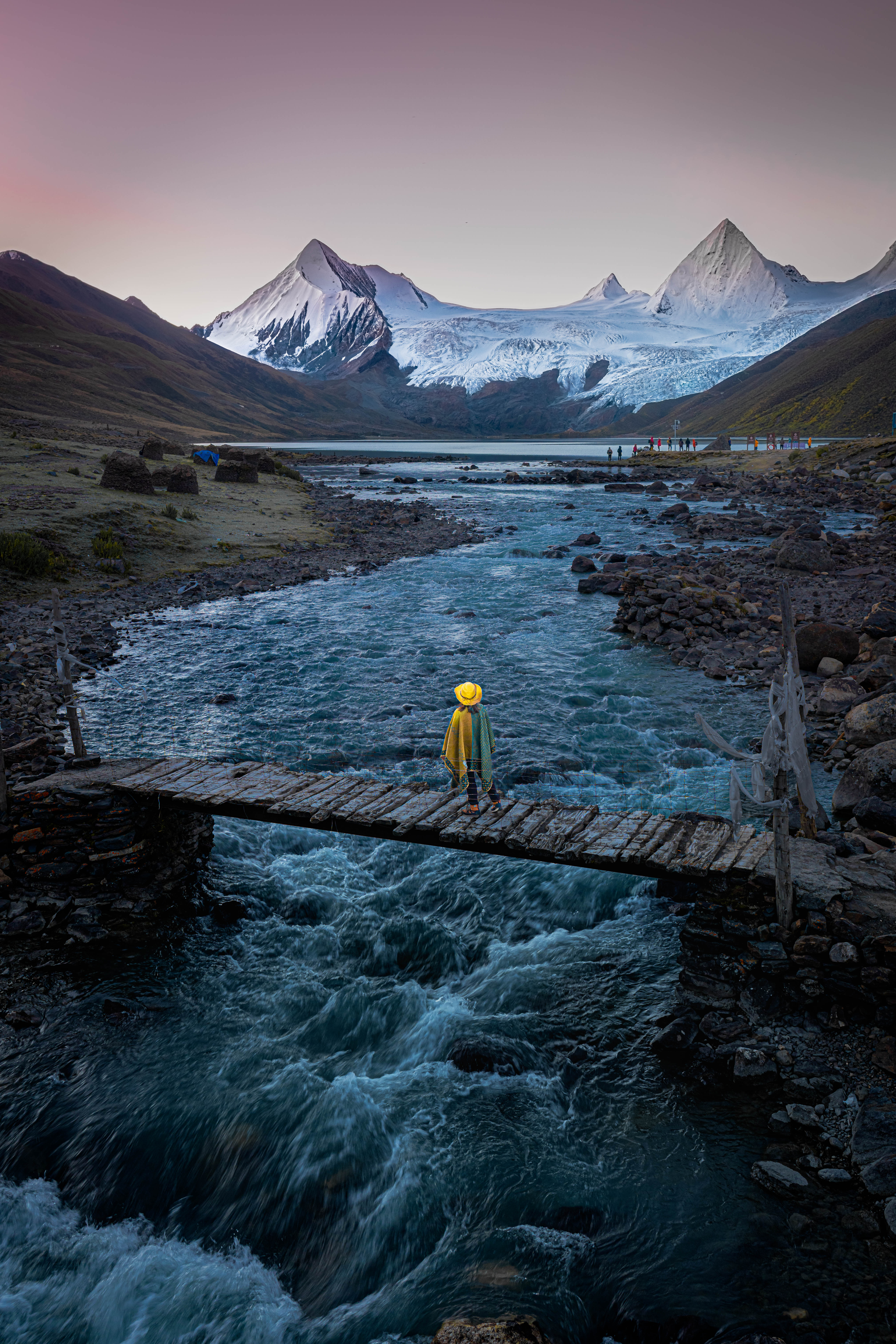 4. “Bridge to the sacred peaks”, Donald Chin
“In an adventure to Tibet Autonomous Region in China, I found myself among the very first foreign travellers permitted into Sepu Kangri, a remote jewel tucked deep within Biru County in the Nagqu prefecture. The place feels untouched, as if the mountains had only just awakened to the idea of visitors. Accommodation is sparse and comforts are few, yet the rawness is precisely what shapes the experience. A simple wooden bridge stretches over the swift, icy runoff from the glacier, serving both local herders and their yak. Standing there, you become part of the quiet choreography between people, animals and the landscape.”