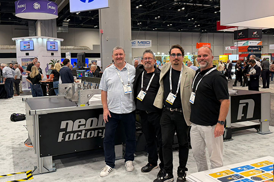 Australian exclusivity: (l-r) Jonny Rumney (Celmac), Mike Osman (Cutworx), Ettore Briccoli Pontiggia (Neolt) and Matt Hall (Celmac) next to the Neolt system at Printing United, where the agreement was struck