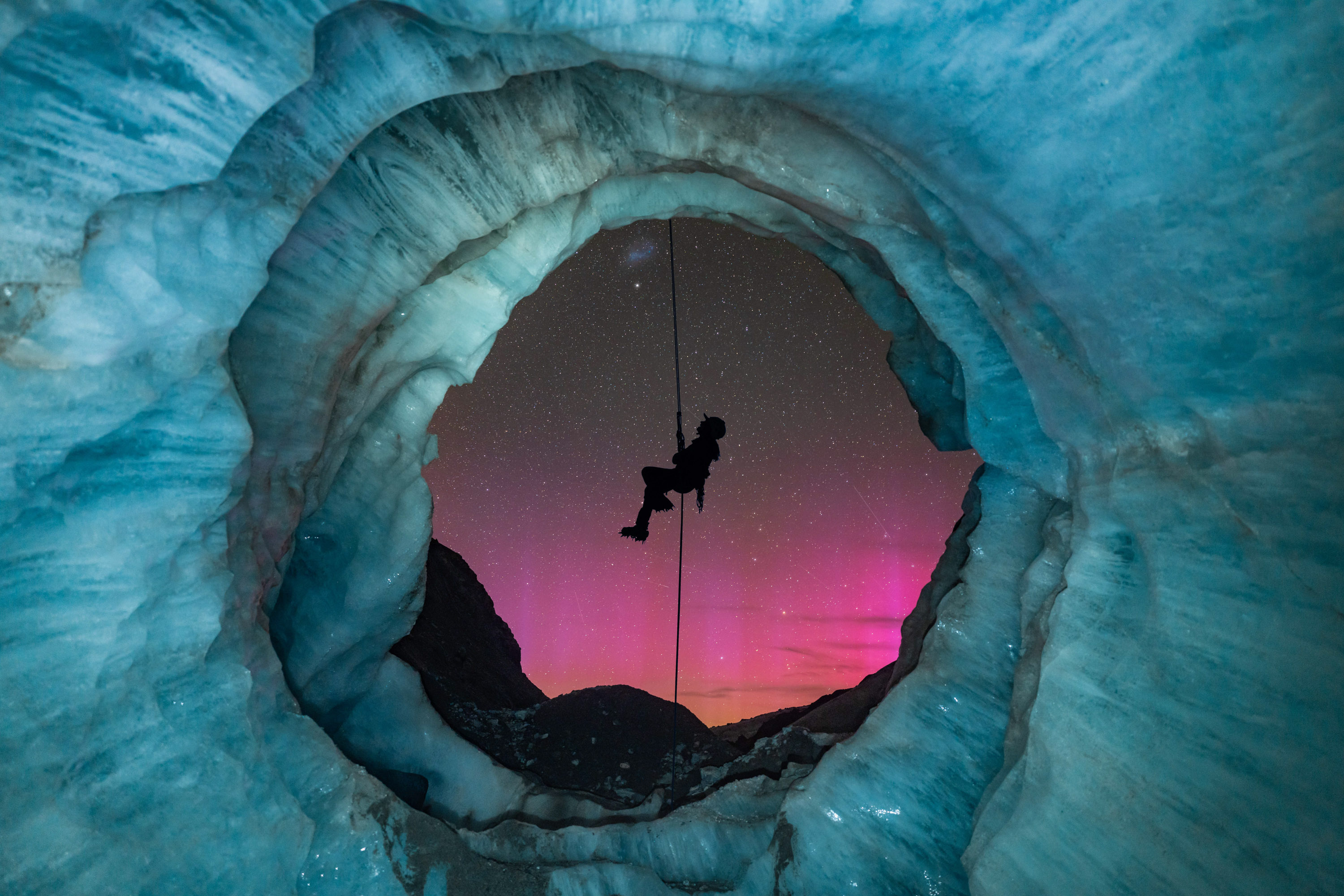 “Lights & Ice” – Tori HarpAoraki/Mt Cook National Park, New ZealandI originally found this ice cave, called a moulin, 8 months prior to setting up this shot in Aoraki/Mount Cook National Park. Glaciers are a very dynamic environment, so I kept going back to monitor the changes of this moulin over the 8-month period. As the opening of the cave formed, I envisioned setting up a night shot with my friend abseiling down the mouth of the cave with New Zealand’s amazing starry sky in the background.