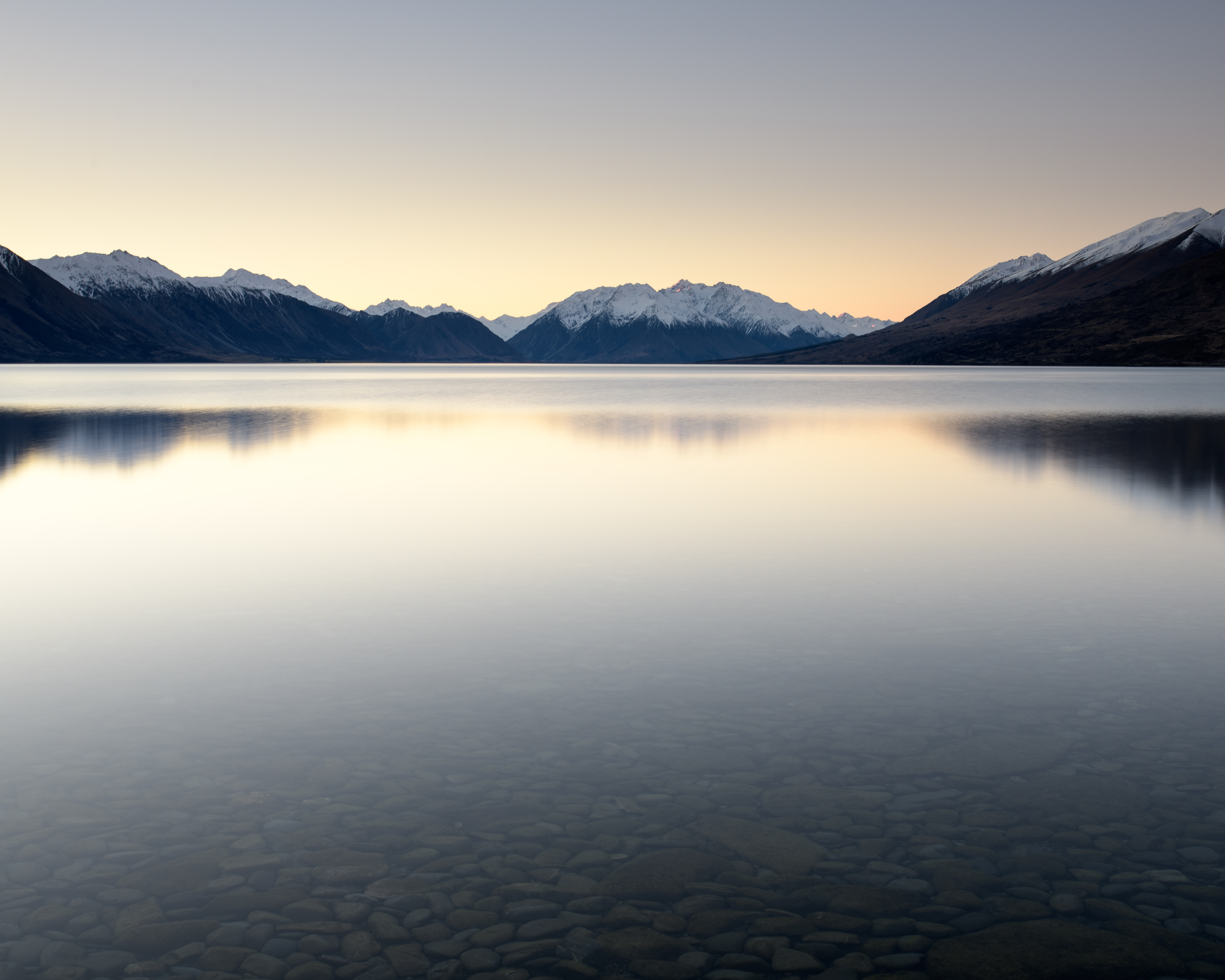 Lake Ohau, Mackenzie Country, New Zealand. The serenity of this peaceful evening is enhanced by a long exposure that smooths the water’s surface into a mirror, reflecting the snow-capped peaks above. Nikon D850, Nikkor 18–35mm lens @ 35mm. 20s @ f11, ISO 64.