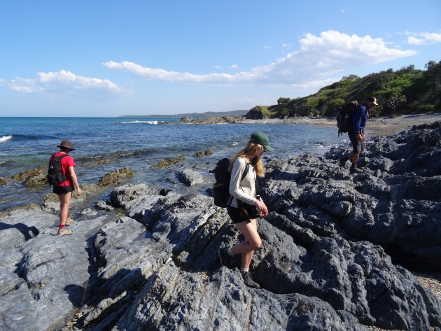 Navigating a rock shelf between Minnie Water and Boorkoom.