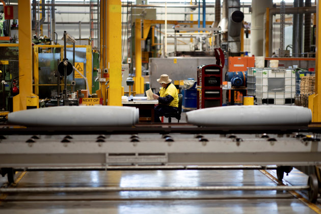 A Thales Australia employee examining munitions during the manufacturing process at the Benalla production line.

Credit: Defence