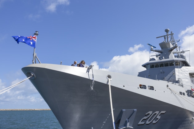 Jessica Shaw, Commissioner, Town of Port Hedland, ceremonially christens NUSHIP Pilbara by breaking a bottle against the hull during the launch ceremony at Henderson Defence Precinct, Western Australia.

Credit: ABIS Jaxsen Shinners / Defence