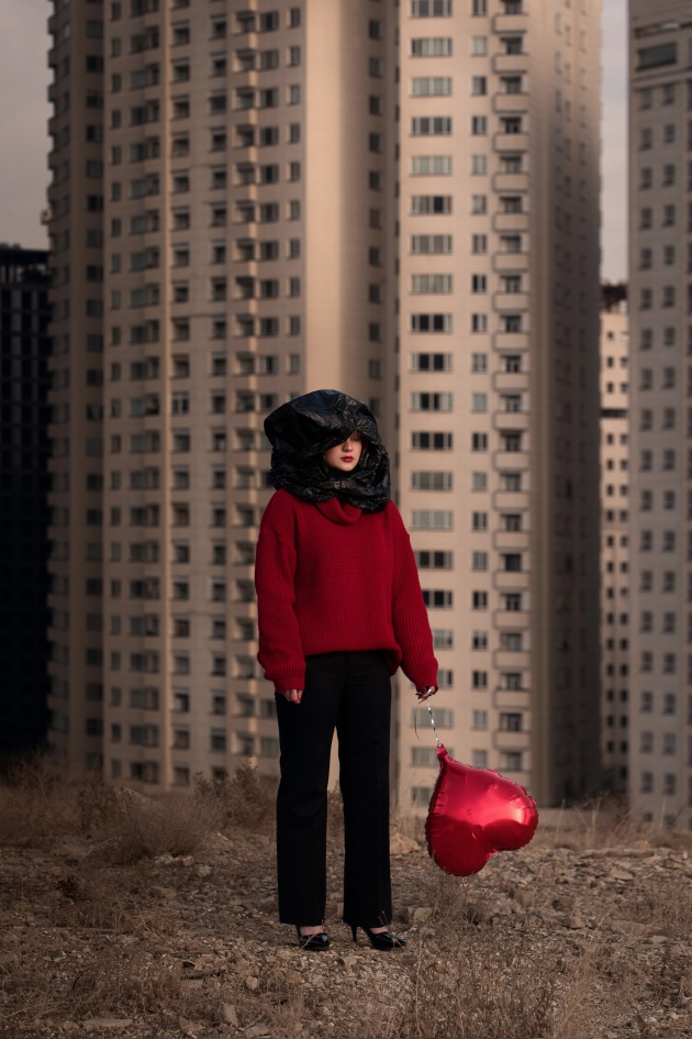 In this image the photographer describes how the black plastic covering most of the woman’s face is a sign of ‘dark thoughts and the imposition of beliefs’, while the red balloon falling to the ground could be ‘her lost hope’. The background evokes Iranian urban society, which has been the setting for the recent demonstrations involving Iranian women, noting that 'the red clothes and lips are the bloody price that women have paid.’
Copyright: © Siavosh Ejlali, Iran, Islamic Republic Of, Winner, Open Competition, Creative, Sony World Photography Awards 2026