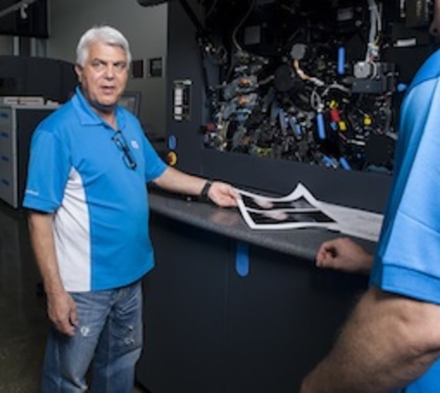 Trainer Alain Barel shows the class the inner-workings of the HP Indigo