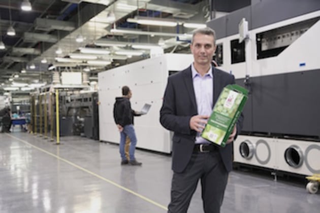 David Tomer with an "offset quality" corrugated package in front of the C500 at the HP Scitex manufacturing plant in Caesarea, Israel.