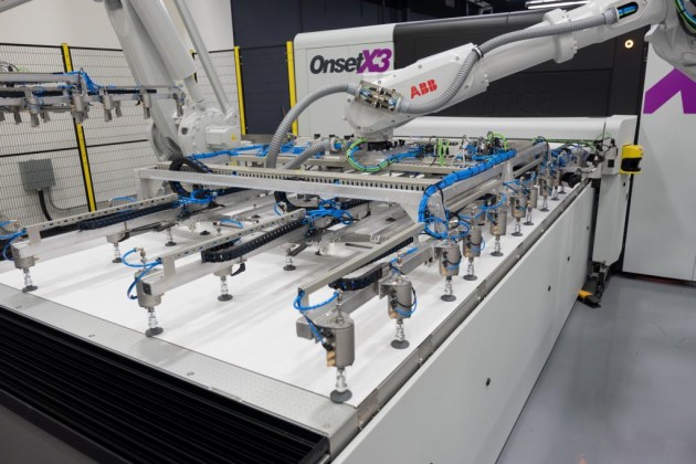 The ABB robotic arm positions another sheet on the bed of an Inca Onset X3.