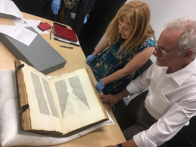 State Library curator Sarah Morley displays a rare 15th C book with its unusual type layout.