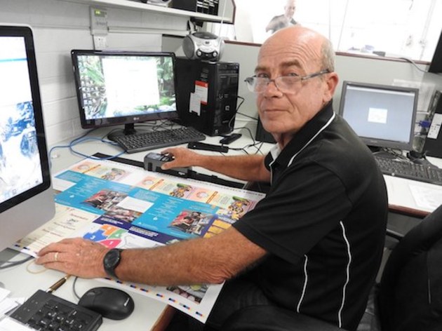 Prepress Manager Laurie Kennedy, checking a proof using the new Techkon SpecroDens.